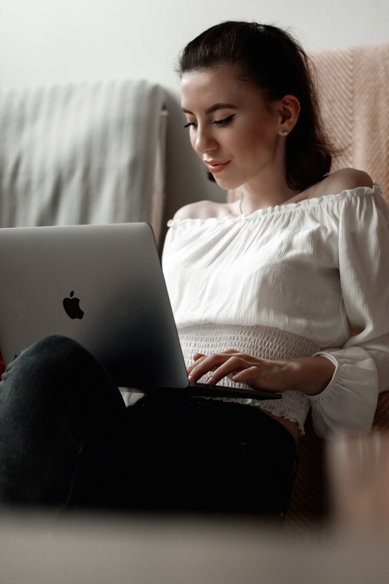 A client settled on the couch during a telehealth session